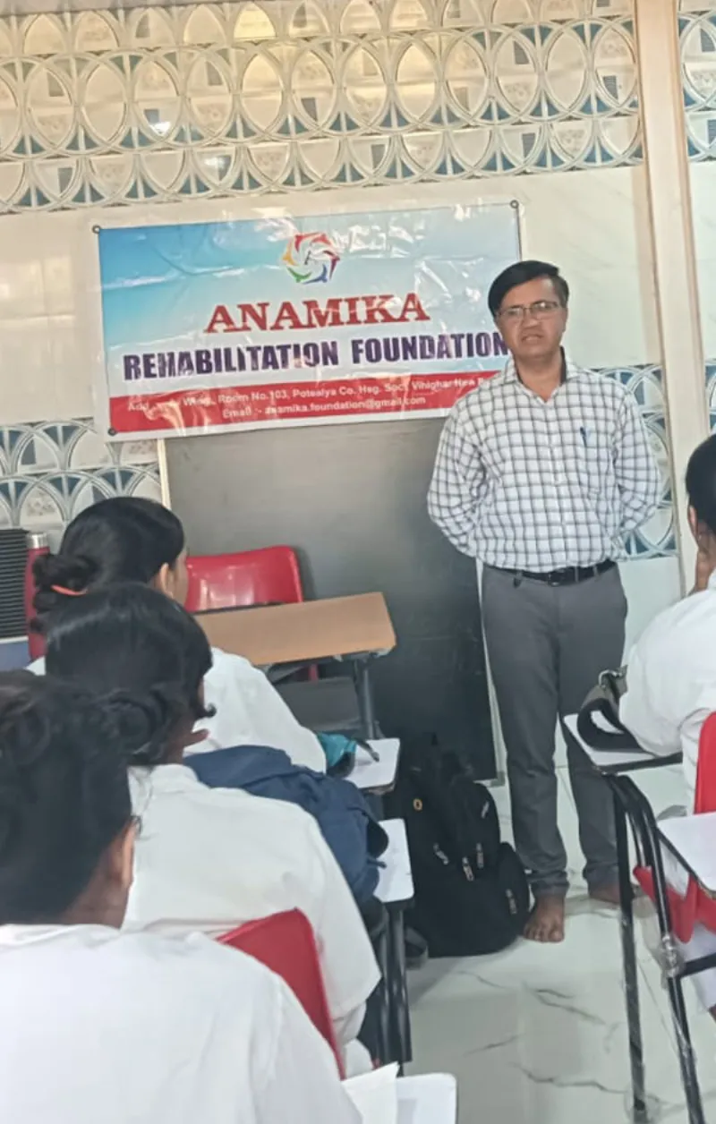 Anamika Foundation team member assisting a child